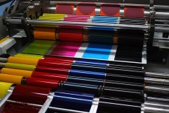 an offset printing press with CMYK ink rollers