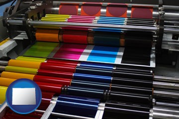 an offset printing press with CMYK ink rollers - with Colorado icon