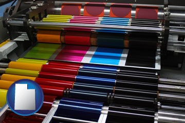 an offset printing press with CMYK ink rollers - with Utah icon