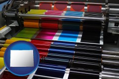 colorado map icon and an offset printing press with CMYK ink rollers