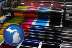 michigan map icon and an offset printing press with CMYK ink rollers