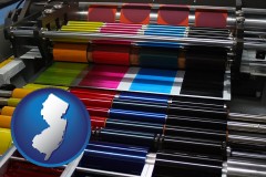 new-jersey map icon and an offset printing press with CMYK ink rollers