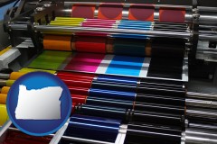 oregon map icon and an offset printing press with CMYK ink rollers